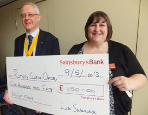 Karen Fincham, from Sainsbury's, presents a cheque to President Elect Philip Burrell